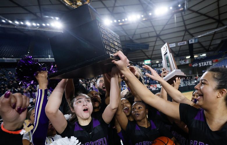 Garfield hoists the trophy after beating Lake Washington 58-49 in the girls 3A state final. 223182