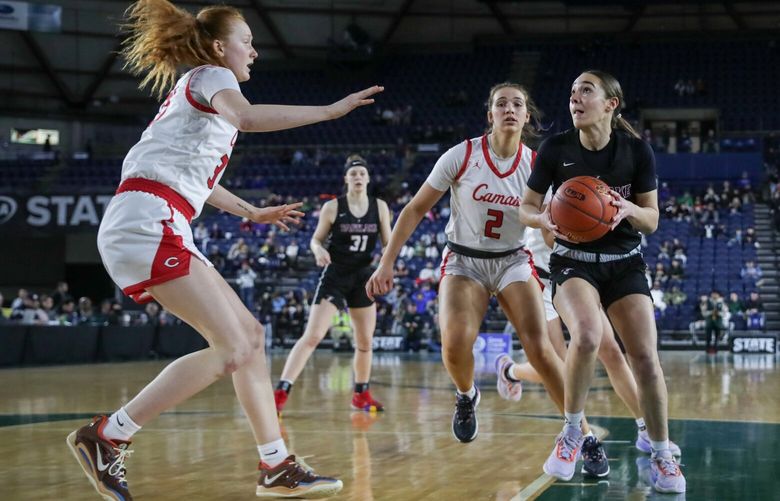Eastlake’s Sofia Aluas, right, drives the lane with Camas’ Kendall Mairs and trailing and Camas’ Addison Harris defending at the Tacoma Dome Saturday night during the 4A girls championship game in Tacoma, Washington on March 4, 2023. Eastlake leads 26-12 at the half.