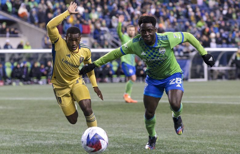 Real Salt Lake midfielder Anderson Julio, left, and Seattle Sounders defender Yeimar Gomez compete for the ball during the first half of an MLS soccer match Saturday, March 4, 2023, in Seattle. (AP Photo/Jason Redmond) WAJR104 WAJR104