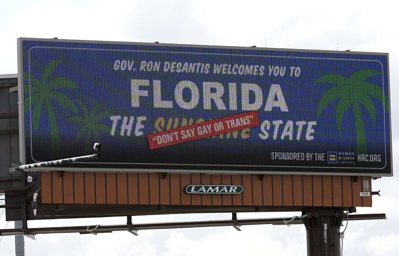 FILE – A new billboard welcoming visitors to “Florida: The Sunshine ‘Don’t Say Gay or Trans’ State,” is seen on April 21, 2022, in Orlando, Fla. Missouri lawmakers feuded Wednesday, March 1, 2023, over a bill that goes farther than what critics have dubbed as Florida’s so-called “Don’t Say Gay” law. (AP Photo/John Raoux, File) NYSS304 NYSS304