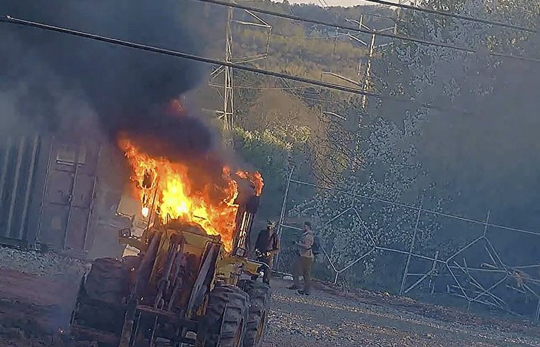 This image provided by the Atlanta Police Department shows construction equipment set on fire Saturday, March 4, 2023 by a group protesting the planned public safety training center, according to police. (Atlanta Police Department via AP) NYPS206 NYPS206