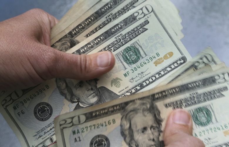 Twenty dollar bills are counted in North Andover, Mass. (AP Photo / Elise Amendola, File) 