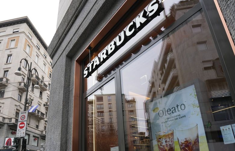 A Starbucks sign advertises the company’s Oleato coffee in one of their coffee shops in Milan, Italy, Monday, Feb. 27, 2023. Putting olive oil in coffee is hardly a tradition in Italy, but that didn’t stop Starbucks founder and CEO Howard Schultz from launching a series of beverages doing just that in Milan, the city that inspired his coffee house empire. (AP Photo/Antonio Calanni) XAC101 XAC101