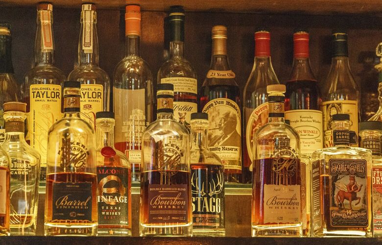 A collection of bottles of Pappy Van Winkle bourbons are seen on the top shelf right, among other fine whiskies at the “Far Bar,” located in the historic Far East Building in the heart of Little Tokyo in Los Angeles on Saturday, March 4, 2023.  Buttery, smooth, oaky. These are characteristics of the best bourbons, and a growing cult of aficionados is willing to pay an astonishing amount of money for these increasingly scarce premium spirits — and even bend or break laws. (AP Photo/Damian Dovarganes) CADD301 CADD301