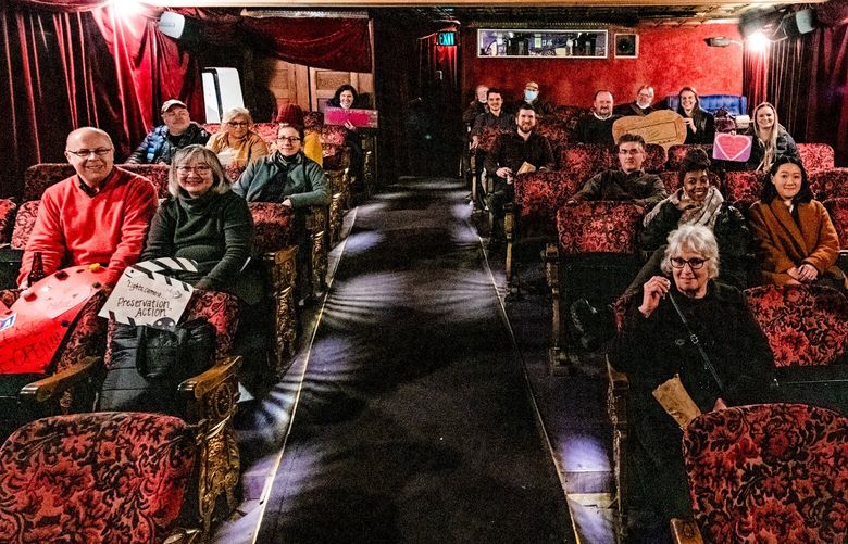 NOW: Historic Seattle volunteers and staff members prepare to enjoy the Seattle-based film “Singles” (1992) at their “heart bomb” photo event at the Grand Illusion Cinema.