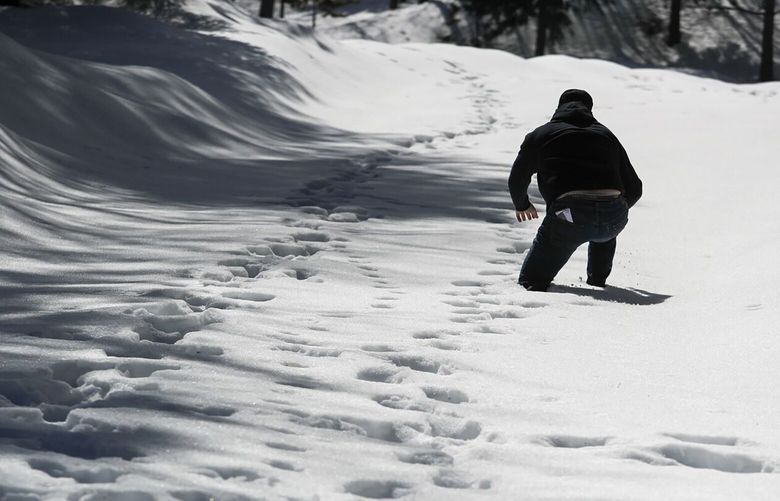 Sandals Church volunteer Dave Mack treks through deep snow as he checks on area residents in the San Bernardino Mountain community of Crestline, California, on Tuesday, March 7, 2023. (Brian van der Brug/Los Angeles Times/TNS)