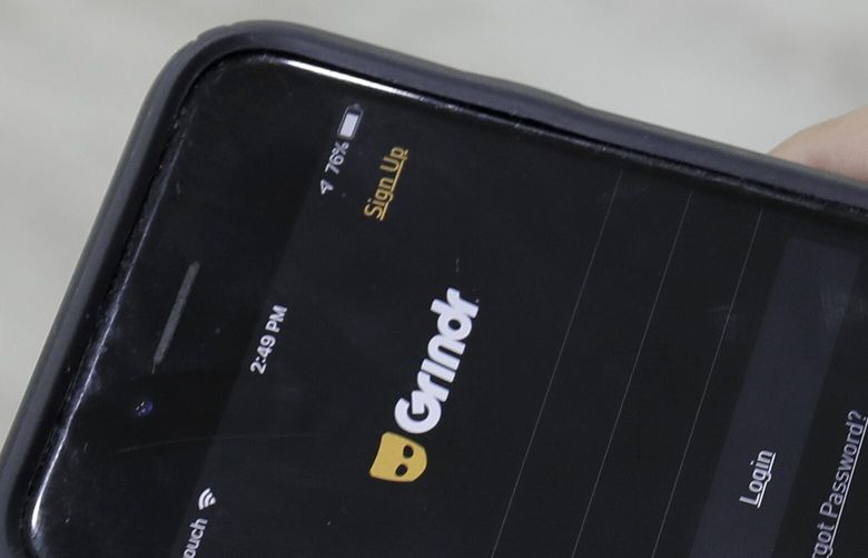 FILE – A person looks at the Grindr app on her mobile phone in Beirut, Lebanon, May 29, 2019. Security agencies and government officials across several countries in the Middle East and North Africa have been using social media platforms and mobile dating apps to track and crack down on LGBTQ people, international rights group Human Rights Watch said Tuesday, Feb. 21, 2023. (AP Photo/Hassan Ammar, File) HAS105 HAS105
