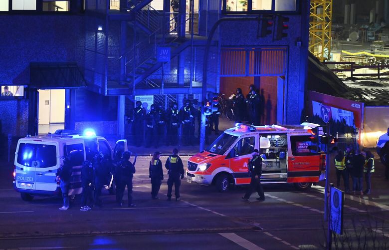 Armed police officers near the scene of a shooting in Hamburg, Germany on Thursday March 9, 2023 after one or more people opened fire in a church. The Hamburg city government says the shooting took place in the Gross Borstel district on Thursday evening. (Jonas Walzberg/dpa via AP) TH803 TH803