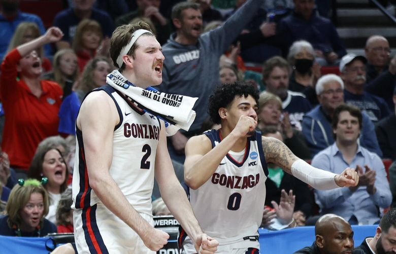 Gonzaga forward Drew Timme (2) and guard Julian Strawther (0) react on the bench during the second half of a first round NCAA college basketball tournament game against Georgia State, Thursday, March 17, 2022, in Portland, Ore. Gonzaga won 93-72. (AP Photo/Craig Mitchelldyer)