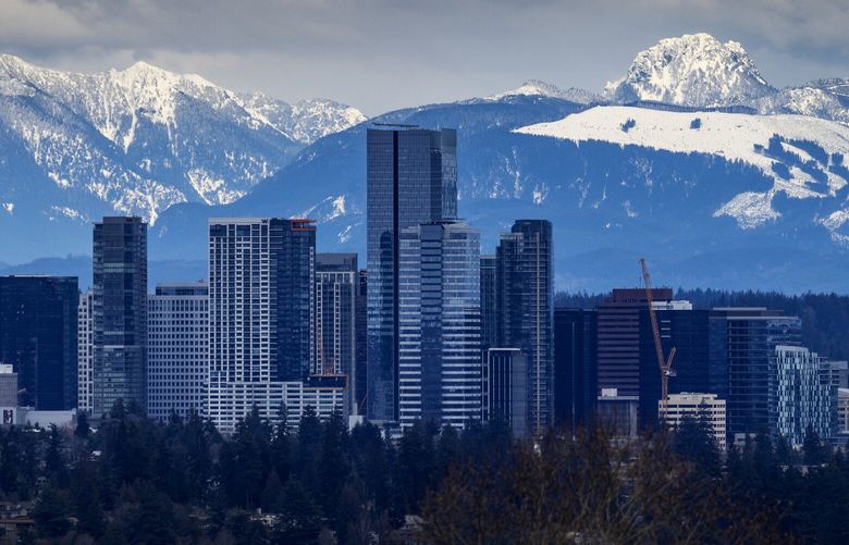 With clocks now set forward and Spring a week away, winter is winding down with a snowy Cascade range appearing behind Bellevue’s developing skyline, seen from Seattle’s Central District neighborhood  last Thursday, March 9, 2023.