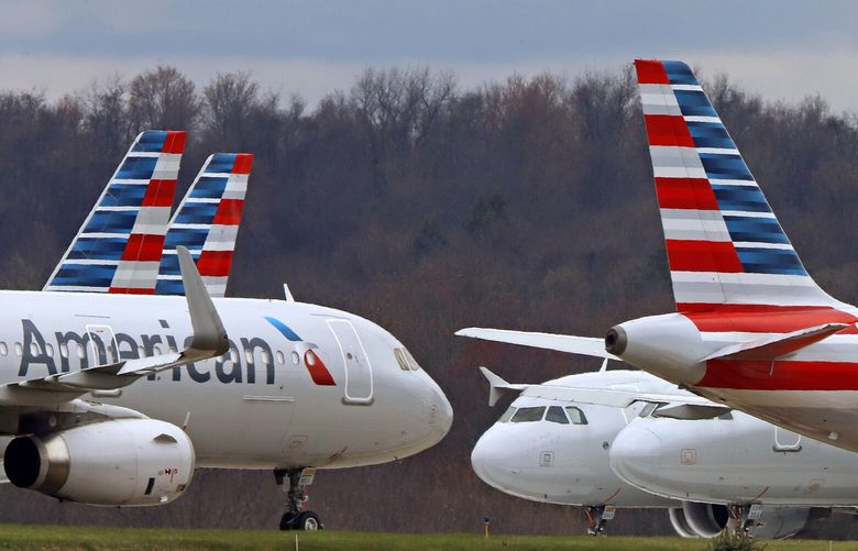 FILE – American Airlines planes sit stored at Pittsburgh International Airport on March 31, 2020, in Imperial, Pa. (AP Photo/Gene J. Puskar, File) 