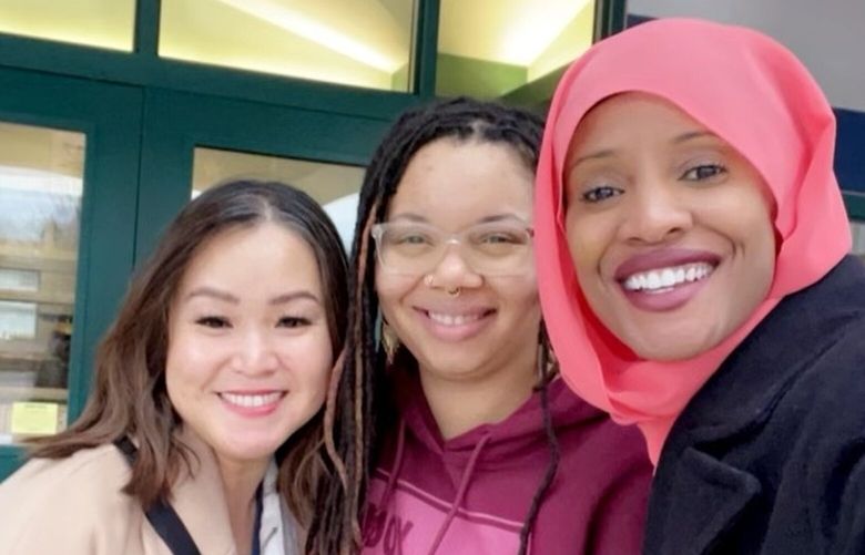 Kent School District employees Andrea Amoranto Victoria (tan jacket) and Netera Pratt-Guiterrez (Red sweater) with Shukri Olow, founder of Ramadan Affirmation Cards Project. (Courtesy of Ramadan Affirmation Cards Project)