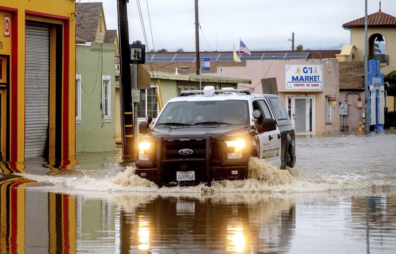 A sheriff’s deputy drives through floodwaters in the community of Pajaro in Monterey County, Calif., on Monday, March 13, 2023. (AP Photo/Noah Berger) CANB111 CANB111