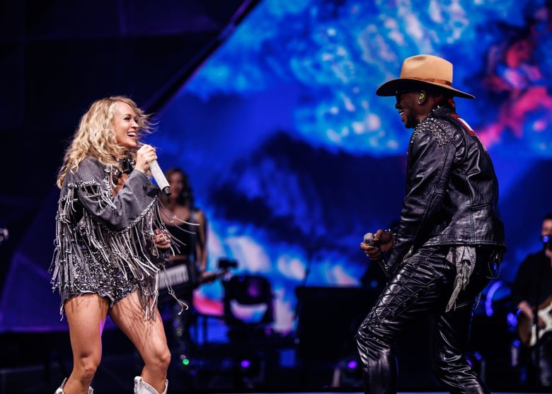 Carrie Underwood and Jimmie Allen, here performing during a previous stop on Underwood’s tour, both fired up the crowd Friday at Climate Pledge Arena. (Jeff Johnson)