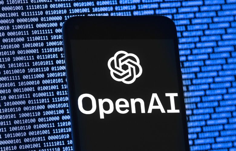 The OpenAI logo appears on a mobile phone in front of a computer screen with random binary data, Thursday, March 9, 2023, in Boston. (AP Photo/Michael Dwyer) 