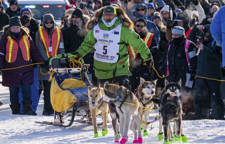 Ryan Redington mushes down Front Street to win the 2023 Iditarod Trail Sled Dog Race Tuesday, March 14, 2023 in Nome, Alaska. Redington, 40, is the grandson of Joe Redington Sr., who helped co-found the arduous race across Alaska that was first held in 1973 and is known as the “Father of the Iditarod.”  (Loren Holmes/Anchorage Daily News via AP) AKAND103 AKAND103