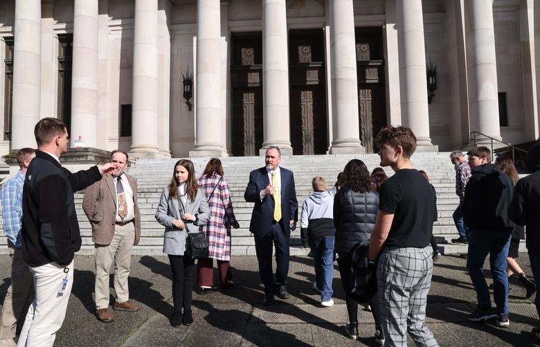Wahkiakum School District Superintendent Brent Freeman, center, speaks with students and staff outside the Temple of Justice in Olympia on Tuesday, March 14, 2023. The Temple of Justice is currently closed for renovation. Earlier they attended a hearing for their School District at the Washington Supreme Court’s temporary location in Tumwater. They came to the Capitol campus afterwards to visit as a social studies lesson and to meet with Rep. Joel McEntire, R-Cathlamet pictured at left. The Wahkiakum School District has sued the State of Washington over the lack of construction funding available to districts that can’t pass a bond. This hearing is the only hearing in the case, which has reached the state Supreme Court. Both sides will present legal arguments and answer questions from the justices. The Court is set to make a decision in the case sometime later this year. If the district wins, it would require the state to fully fund all essential construction projects in the state.