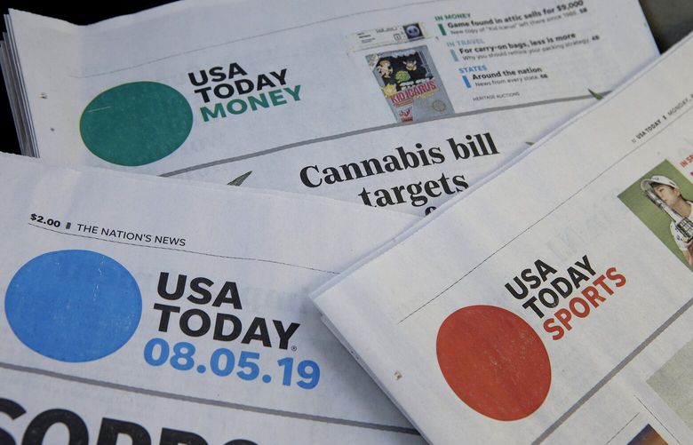 FILE – Sections of a USA Today newspaper lie on display, Aug. 5, 2019, in Norwood, Mass. On Friday, Aug. 12, 2022, newspaper publisher Gannett Co., confirmed that itâ€™s laying off some of its newsroom staff, part of a cost-cutting effort to lower its expenses as revenue crumbles amid a downturn in ad sales and customer subscriptions. (AP Photo/Steven Senne, File)