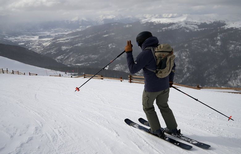 A skier goes down a hill at Arapahoe Basin Ski Area on Friday, Jan. 20, 2023, in Dillon, Colo. As global warming threatens to put much of the ski industry out of business over the next several decades, resorts are beginning to embrace a role as climate activists. (AP Photo/Brittany Peterson) CLI201 CLI201