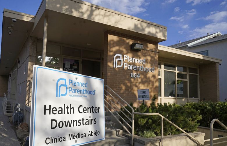 FILE – A sign is shown in front of Planned Parenthood of Utah Tuesday, June 28, 2022, in Salt Lake City. Utah Gov. Spencer Cox signed legislation on Wednesday, March 15, 2023, that will effectively ban clinics from providing abortions, setting off a rush of confusion among clinics, hospitals and prospective patients in the deeply Republican state. With the law set to start taking effect May 3, both the Planned Parenthood Association of Utah and the Utah Hospital Association declined to detail how the increasingly fraught legal landscape for abortion providers in Utah will affect their operations.  (AP Photo/Rick Bowmer, File) UTRB104 UTRB104