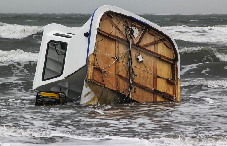 The pilot house bridge from the F/V Ethel May is pounded in the surf Monday February 6, the day after the boat sank near the mouth of Willapa Bay.