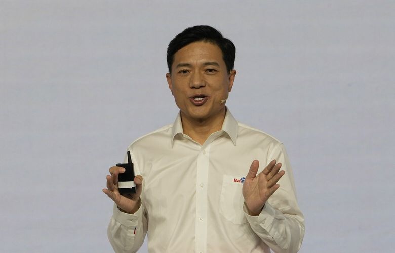 Baidu CEO Robin Li introduces the functions of Ernie Bot during an event in Beijing, Thursday, March 16, 2023. Chinese search giant Baidu on Thursday unveiled its artificial intelligence chatbot Ernie Bot, with its CEO saying that there was high market demand as Chinese companies raced to develop an equivalent of Microsoft-backed ChatGPT.  (AP Photo/Ng Han Guan) XHG102 XHG102