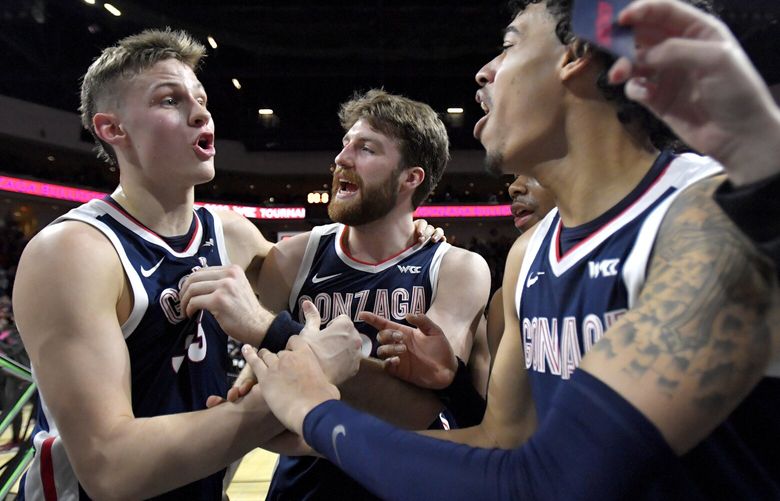 Gonzaga forward Ben Gregg, forward Drew Timme and guard Julian Strawther, from left, celebrate after the team defeated Saint Mary’s in an NCAA college basketball game in the finals of the West Coast Conference men’s tournament Tuesday, March 7, 2023, in Las Vegas. (AP Photo/David Becker) NVDB176 NVDB176