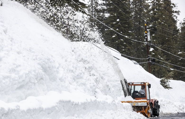 A snowblower removes snow in Tahoe City, Calif. Tuesday, March 14, 2023. (Stephen Lam/San Francisco Chronicle via AP) CAFRA404 CAFRA404