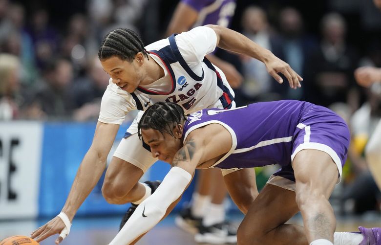 Grand Canyon guard Chance McMillian, front, and Gonzaga center Efton Reid III pursue the ball during the first half of a first-round college basketball game in the men’s NCAA Tournament Friday, March 17, 2023, in Denver. (AP Photo/David Zalubowski)