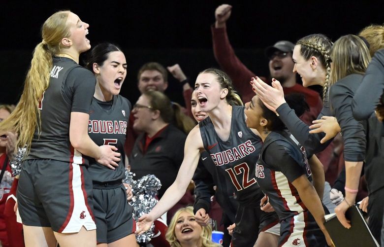 Washington State celebrates a 3-point basket by guard Charlisse Leger-Walker, second from left, during the second half of an NCAA college basketball game against UCLA in the finals of the Pac-12 women’s tournament Sunday, March 5, 2023, in Las Vegas. (AP Photo/David Becker) NVDB131 NVDB131