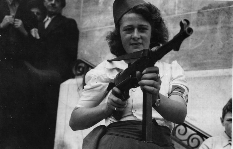 A photo provided by the National Archives shows Simone Segouin, known by her nom de guerre, Nicole, at age 17 in 1944, after helping to capture 25 German soldiers in France. Segoiuin, who was portrayed in Life magazine in 1944 as a simple farm girl brandishing a submachine gun who became an international symbol of the partisans who helped defeat the Nazis, died in Courville-sur-Eure, France, on Feb. 21, 2023. She was 97. (National Archives via The New York Times) — EDITORIAL USE ONLY; NO SALES —  XNYT119 XNYT119