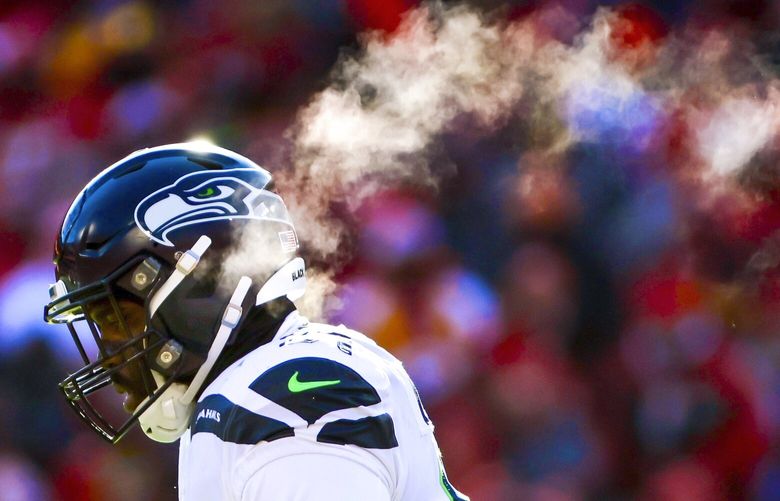 Seattle Seahawks defensive end L.J. Collier’s breath flows out behind him as he walks back to the bench during the first quarter. 222506