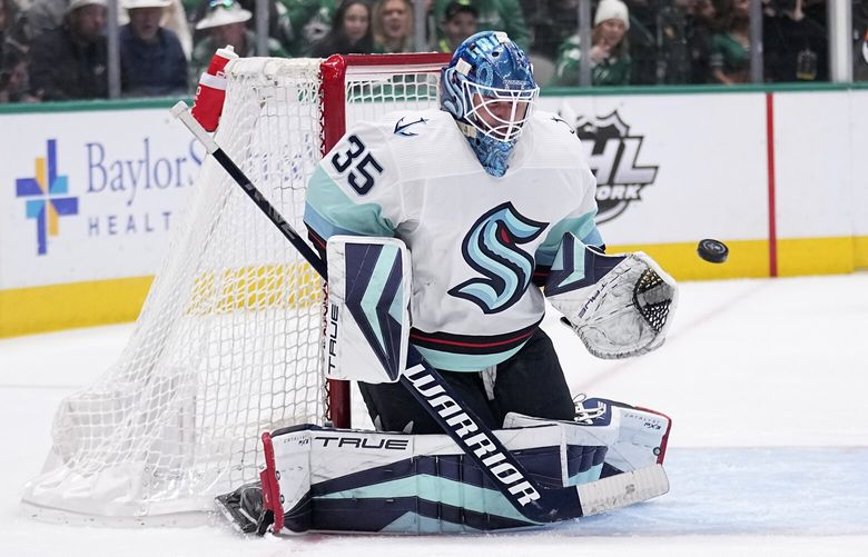 Seattle Kraken goaltender Joey Daccord (35) defends against a shot by the Dallas Stars in the first period of an NHL hockey game, Tuesday, March 21, 2023, in Dallas. (AP Photo/Tony Gutierrez)