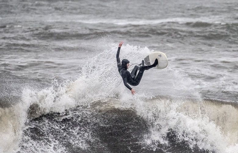 A surfer rides his board at Cowell Beach during the latest atmospheric storm event in Santa Cruz, Calif. Tuesday, March 21, 2023. (Stephen Lam/San Francisco Chronicle via AP) CAFRA201 CAFRA201