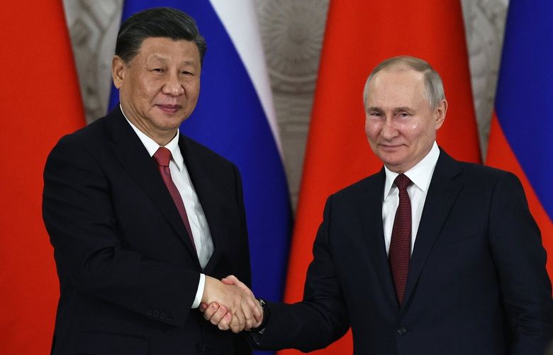 FILE – Russian President Vladimir Putin, right, and Chinese President Xi Jinping shake hands after speaking to the media during a signing ceremony following their talks at The Grand Kremlin Palace, in Moscow, Russia, March 21, 2023. China’s leader Xi just concluded his three-day visit with Russian President Vladimir Putin, a warm affair in which the two men praised each other and spoke of a profound friendship. It’s a high in a complicated, centuries-long relationship in which the two countries have been allies and enemies.(Mikhail Tereshchenko, Sputnik, Kremlin Pool Photo via AP, File) XBEJ201 XBEJ201