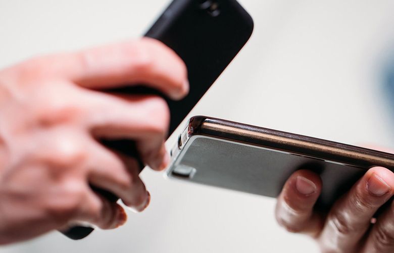 close up of two person using mobiles. business concept