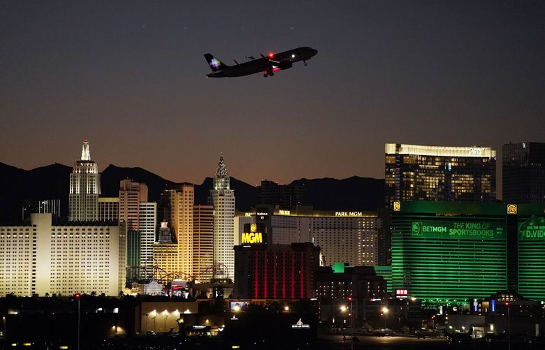 FILE – A plane takes off from Harry Reid International Airport near casinos along the Las Vegas Strip, Sept. 29, 2021, in Las Vegas. The year 2022 was good for gambling and tourism in Nevada. New data posted Tuesday, Jan. 31, 2023, showed house winnings at casinos statewide set calendar year records and visitor tallies in Las Vegas nearly reached levels seen before the coronavirus pandemic. (AP Photo/John Locher, File)