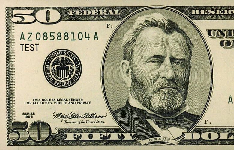 FILE–The Treasury Department unveiled in Washington the new version of the $50 bill in this file photo from June 1997. The bills aimed at preventing counterfeiting, feature a larger portrait of Ulysses S. Grant, a security thread and color shifting ink in the numeral on the lower-right corner of the bill.  An estimated 30 million copies of the redesigned $50 bill is being withheld from circulation because of a tiny printing flaw, the Treasury Department said Wednesday, Sept. 24, 1997.  A decision hasn’t been made yet whether to destroy the flawed bills, which cost $1.44 million to produce, or put them into circulation later. (AP Photo/Treasury Department)