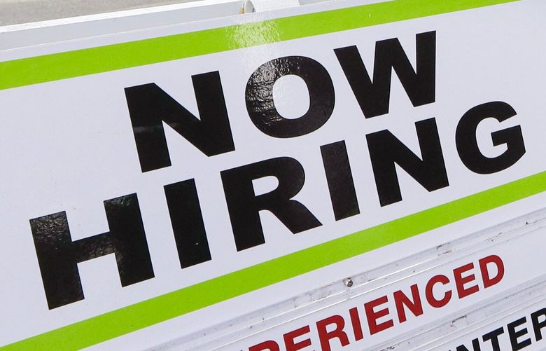 FILE – In this June 4, 2020 file photo, a pedestrian wearing a mask walks past a reader board advertising a job opening for a remodeling company, in Seattle. U.S. companies added nearly 2.4 million jobs in June, according to a private survey, a large gain that still leaves the job market far below its pre-pandemic levels. The payroll company ADP said that small businesses reported the largest gain, adding 937,000 jobs. Construction firms and restaurants and hotels also posted big increases in hiring. (AP Photo/Elaine Thompson, File) NYBZ950