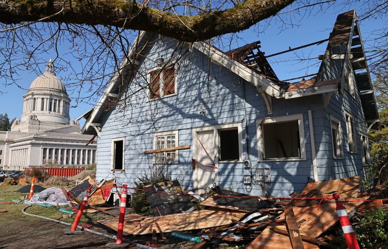 The Carlyon House, also known as the Blue House, during its deconstruction by the Hoffman Construction Company in Olympia, Washington, on Wednesday, March 22, 2023. Its deconstruction is part of the Legislative Campus Modernization (LCM) project to replace and renovate aging buildings on the West Capitol Campus. The house was occupied by members of the Capitol Press Corps between the early 1980s and 2021. The Capitol Press Corps moved into new space in the Legislative Building earlier this year. DES is taking steps to offset the loss of those historic buildings through a process called historic mitigation. Salvage, starting with the roof, is the first step in deconstruction.