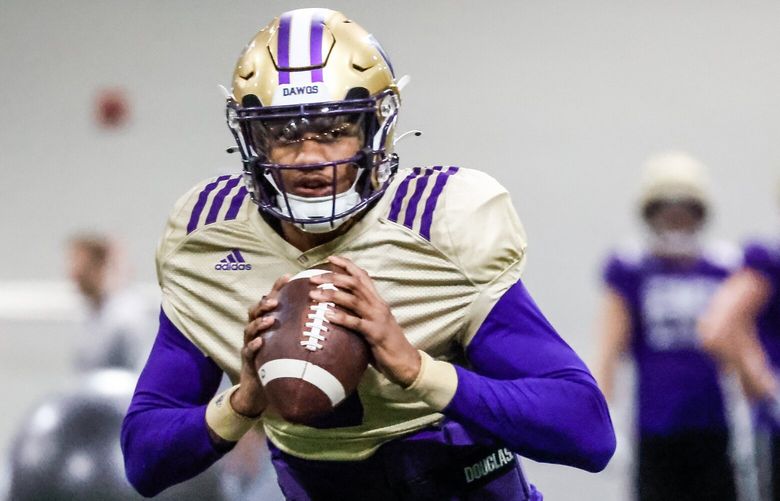 Quarterback Michael Penix, Jr. looks to pass Friday morning during spring practice at the Dempsey Indoor Center in Seattle, Washington on March 10, 2023.