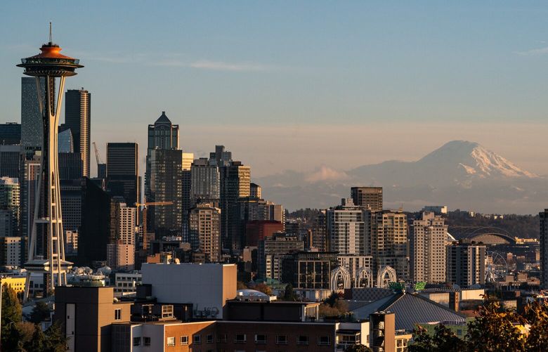 Mount Rainier looms behind the Seattle skyline at sunset on Tuesday, Nov. 8, 2022, as seen from Kerry Park.