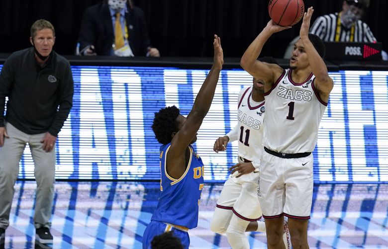 Gonzaga guard Jalen Suggs (1) shoots over UCLA guard David Singleton (34) to win the game during overtime in a men’s Final Four NCAA college basketball tournament semifinal game, Saturday, April 3, 2021, at Lucas Oil Stadium in Indianapolis. Gonzaga won 93-90. (AP Photo/Michael Conroy)