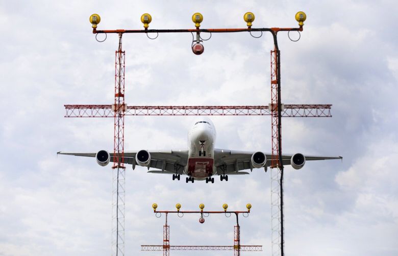 A commercial airliner prepares to land in Canada. Photographer: Brent Lewin/Bloomberg
