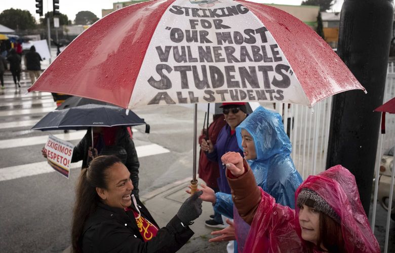 SEIU workers, teachers and supporters picket at Mclay Street and Foothill Blvd in San Fernando, Calif., Thursday, March 23, 2023, on the third day of a strike by SEIU and supported by UTLA for higher wages for Angeles Unified School District support staff. The 3-day strike left thousands of students out of class. (David Crane/The Orange County Register via AP) CAANR204 CAANR204