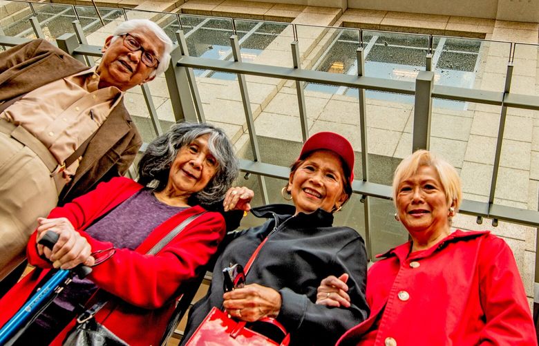 NOW: Standing in front of the 24-floor 1700 Stewart building, completed in 2001, along the northeast side of Seventh Avenue, former site of The Door entrance, are Ben Laigo and three of his sisters who worked with him at the coffeehouse: (from left) Dorothy Laigo Cordova, Marya Castillano Bergstrom and Jeanette Castillano Tiffany. For a detailed essay on The Door by Ben Laigo, of Shoreline, visit PaulDorpat.com.