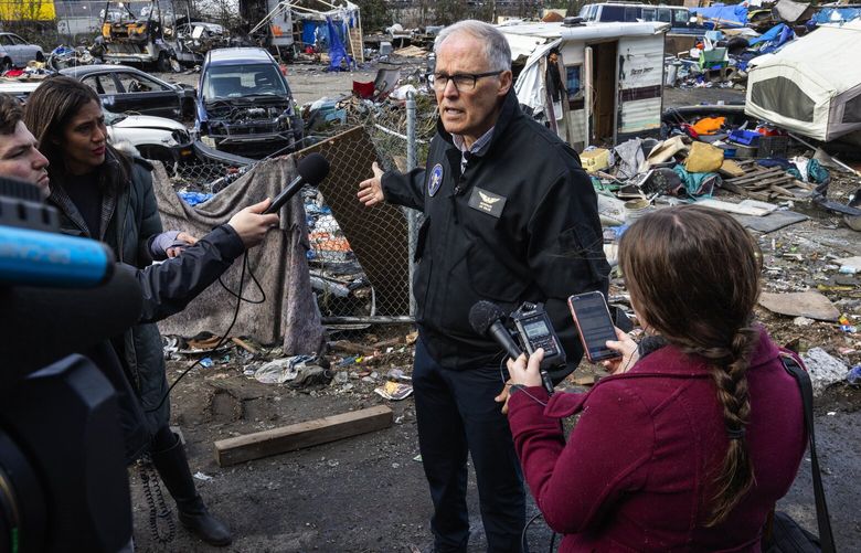 Governor Jay Inslee holds a press conference after touring an encampment that was recently cleared along the north edge of South Park, Tuesday, March 21, 2023. 35 people were previously living here. The state began its Right of Way Safety Initiative a year ago to try to clear encampments from some state Right of Ways, saying it was a safety hazard to drivers and state employees who needed to maintain these areas. They’ve been trying to do it the “right way” and make meaningful offers of shelter to people living there.