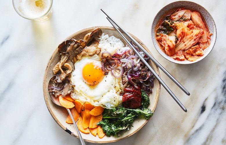 FILE – Sheet-pan bibimbap, in New York, April 27, 2021. Bibimbap, the Korean mixed rice dish, is a kaleidoscope of flavors and textures. Food styled by Judy Kim. (Linda Xiao/The New York Times)