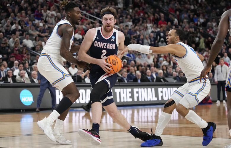 Gonzaga’s Drew Timme (2) works towards the basket against UCLA’s Kenneth Nwuba, left, and Amari Bailey in the first half of a Sweet 16 college basketball game in the West Regional of the NCAA Tournament, Thursday, March 23, 2023, in Las Vegas. (AP Photo/John Locher)