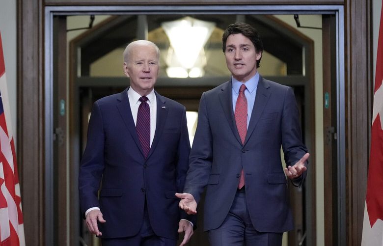 President Joe Biden walks with Canadian Prime Minister Justin Trudeau during an arrival ceremony at Parliament Hill, Friday, March 24, 2023, in Ottawa, Canada. (AP Photo/Andrew Harnik) CANA407 CANA407